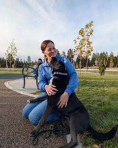 Woman managing a dog jumping up during a greeting