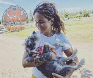 Small puppy resting in owner's arms after playtime